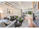 Comfortable living area with hardwood floors, modern lighting, and an open view of dining area and city park at 1620 Little Raven St # 103, Denver, CO 80202