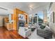 Cozy living room with hardwood floors, a modern fireplace, and large windows overlooking the community park at 1620 Little Raven St # 103, Denver, CO 80202