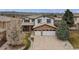 Two story home with a stone accent, three car garage, and professionally landscaped yard at 9249 Fox Fire Dr, Highlands Ranch, CO 80129