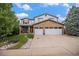 Two-story home featuring a two-car garage, stone accents, and a manicured lawn at 9249 Fox Fire Dr, Highlands Ranch, CO 80129