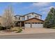 Attractive two-story home with a stone accent facade, two-car garage, and a well-manicured front lawn at 9249 Fox Fire Dr, Highlands Ranch, CO 80129