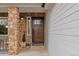 Charming home entrance featuring a beautiful wood door, stone accents, and a welcoming decor at 9249 Fox Fire Dr, Highlands Ranch, CO 80129