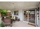 Inviting covered patio with comfortable seating, decorative accents, and sliding glass door to indoors at 9249 Fox Fire Dr, Highlands Ranch, CO 80129