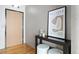 Condo entryway with wood door, console table, and modern art at 1863 Wazee St # 6E, Denver, CO 80202