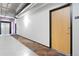 Hallway view featuring apartment door and carpeting, with an exit sign and elevator bank visible at 1863 Wazee St # 6E, Denver, CO 80202