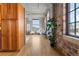 Light-filled hallway with hardwood floors and exposed brick at 1863 Wazee St # 6E, Denver, CO 80202