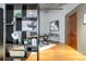 Stylish home office design with wood floors, black shelving, modern art, and a sleek work space at 1863 Wazee St # 6E, Denver, CO 80202