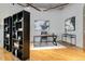 Bright home office features hardwood floors, modern art, sleek black shelving, and a comfortable workspace at 1863 Wazee St # 6E, Denver, CO 80202