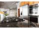 Bright kitchen boasts a gas stovetop, stainless steel appliances, wood cabinets, and hardwood floors at 1863 Wazee St # 6E, Denver, CO 80202
