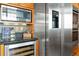 Updated kitchen with stainless steel appliances including a wine fridge, black countertops, and wood cabinetry at 1863 Wazee St # 6E, Denver, CO 80202