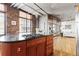 Contemporary kitchen with a gas stovetop, wood cabinets, brick wall, and hardwood floors at 1863 Wazee St # 6E, Denver, CO 80202