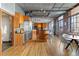 Spacious industrial kitchen features wood cabinets, stainless steel appliances, and a breakfast bar with seating at 1863 Wazee St # 6E, Denver, CO 80202