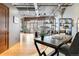 Spacious living area with exposed ceilings, hardwood floors, large windows, and modern decor at 1863 Wazee St # 6E, Denver, CO 80202