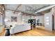 Modern living room with exposed pipes, hardwood floors, white couch, and a contemporary black bookshelf at 1863 Wazee St # 6E, Denver, CO 80202