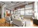 Bright living room boasts hardwood floors, expansive windows, and modern furnishings at 1863 Wazee St # 6E, Denver, CO 80202