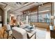 Bright living room featuring exposed pipes, concrete ceilings, and oversized windows with views of the city at 1863 Wazee St # 6E, Denver, CO 80202
