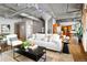 Open-concept living room with exposed ceiling details, hardwood floors, and modern furnishings at 1863 Wazee St # 6E, Denver, CO 80202