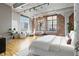 Large bedroom with hardwood floors and exposed brick wall at 1863 Wazee St # 6E, Denver, CO 80202