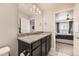 Bathroom vanity with a granite countertop and dark cabinetry next to the primary bedroom at 23545 E Platte Dr # C, Aurora, CO 80016