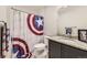 Bathroom features a Captain America shower curtain, granite countertop, and gray cabinetry at 23545 E Platte Dr # C, Aurora, CO 80016