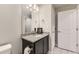 Bathroom featuring a granite countertop, dark cabinetry, and a large mirror at 23545 E Platte Dr # C, Aurora, CO 80016