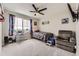 Cozy bedroom features carpet flooring, ceiling fan, and a bright window with superhero themed decor at 23545 E Platte Dr # C, Aurora, CO 80016