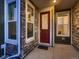 Charming entryway featuring a glass paneled red door, stone accents, and sidelight windows at 23545 E Platte Dr # C, Aurora, CO 80016