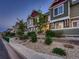 Exterior view of townhouses showing green siding, landscaped front yard, and a sidewalk at 23545 E Platte Dr # C, Aurora, CO 80016