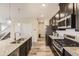Open kitchen featuring granite counters, a stainless steel oven, and a large island at 23545 E Platte Dr # C, Aurora, CO 80016