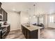 Open-concept kitchen with a granite island and modern lighting at 23545 E Platte Dr # C, Aurora, CO 80016