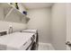 Laundry room features a new Samsung washer and dryer and open shelving at 23545 E Platte Dr # C, Aurora, CO 80016