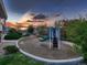 Community playground area with a slide and sunset sky in the background at 23545 E Platte Dr # C, Aurora, CO 80016