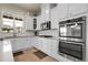 Bright kitchen with white cabinets, stainless steel appliances, and a large window offering plenty of natural light at 25059 E Alder Dr, Aurora, CO 80016
