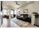 Comfortable upstairs living room with a sleek black leather recliner, modern ceiling fan, and access to an outdoor balcony at 25059 E Alder Dr, Aurora, CO 80016