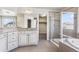 A luxurious bathroom features a dual sink vanity, glass shower, and soaking tub at 3823 Horiuchi St, Brighton, CO 80601