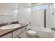 A clean, bright bathroom features a combination tub and shower with stylish tile accents, and a vanity with ample storage at 3823 Horiuchi St, Brighton, CO 80601