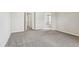 Neutral-carpeted bedroom has two doors leading to an ensuite bath at 3823 Horiuchi St, Brighton, CO 80601
