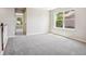 A secondary bedroom has neutral carpet and lots of natural light at 3823 Horiuchi St, Brighton, CO 80601