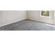 A cozy bedroom space featuring neutral walls, carpet, and natural light from a window at 3823 Horiuchi St, Brighton, CO 80601