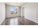 Dining room featuring hardwood floors, modern chandelier, and large window at 3823 Horiuchi St, Brighton, CO 80601