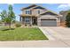 Two-story home with a well-manicured front yard, stone accents, and a covered porch at 3823 Horiuchi St, Brighton, CO 80601