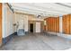 Spacious garage with ample room for parking and storage, including a pedestrian door to the interior at 3823 Horiuchi St, Brighton, CO 80601