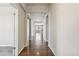 Spacious hallway with hardwood floors leading to various rooms in the home at 3823 Horiuchi St, Brighton, CO 80601