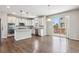 Bright kitchen has stainless appliances, granite counters, and a breakfast nook with access to the patio at 3823 Horiuchi St, Brighton, CO 80601