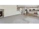 Open-concept living room and kitchen features a fireplace, stairs, and plenty of room at 3823 Horiuchi St, Brighton, CO 80601