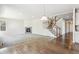 Open-concept space with both hardwood flooring and carpeting features a modern fireplace and staircase at 3823 Horiuchi St, Brighton, CO 80601