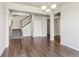 Open-concept living room with hardwood floors, staircase, and modern finishes at 3823 Horiuchi St, Brighton, CO 80601