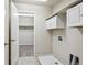 Convenient utility room featuring tile flooring, built-in storage, and access to a large walk-in closet at 3823 Horiuchi St, Brighton, CO 80601