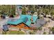 Aerial view of a house featuring a well-maintained deck and solar panels, nestled among lush green trees at 14800 Gold Hill Rd, Boulder, CO 80302