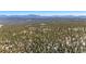 An aerial view of a treed lot with mountains in the background at 14800 Gold Hill Rd, Boulder, CO 80302